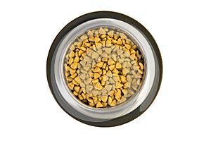 Metal feeding bowl filled with cat kibble seen from a high angle