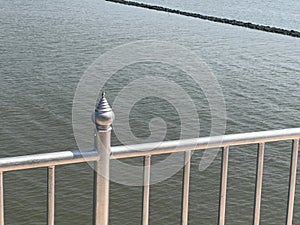 metal fence on the background of the sea