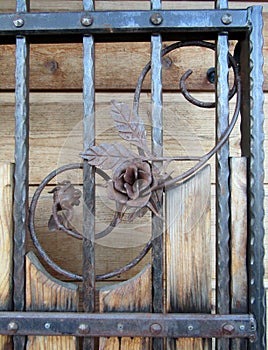 Metal fence decorated with wrought-iron decorative roses