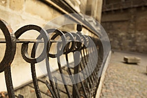 Metal fence near the stone wall l in Lviv