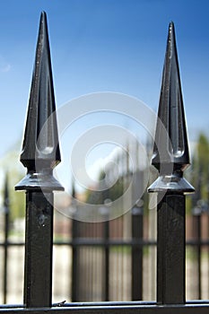 Metal fence over blue sky