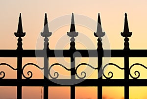 Metal fence at sunset