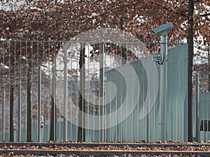 Metal fence with video cameras photo