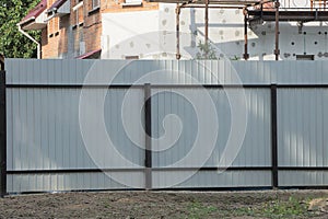 metal fence wall with a black iron frame on a rural street