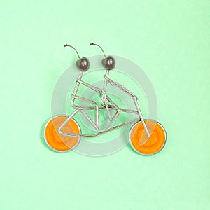 Metal figures of sportsmen on bicycle with wheels from carrot
