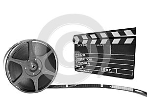 Metal film reel and clapperboard on a black backgr