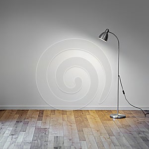 Metal floor lamp in empty room with shadow on white wall, copy space for text