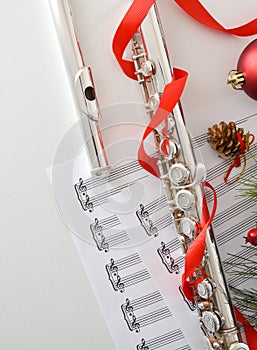 Metal flute detail music and Christmas decoration on white table