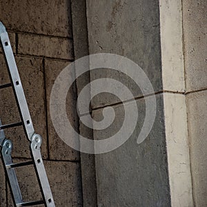 Metal folding staircase at the stone building