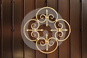 Metal forged pattern painted with gold color paint, decorating a fence or gate