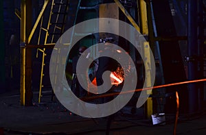 Metal forging, forging shop. Hydraulic hammer shapes the red-hot billet.