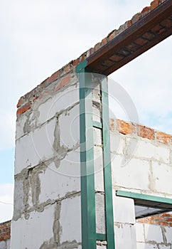 Metal frame for earthquake building protection.Earthquake-resistant structures with metal frames on entrance and window lintels.