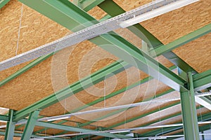 Metal framework of hangar. Metal supporting structures. Beams and girders of truss ceiling