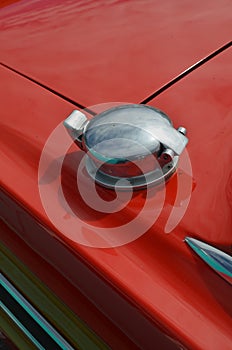 Metal fuel filler cap on classic car.