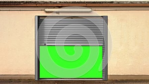 Metal garage door opening with green screen