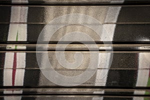 Metal garage door texture with graffiti close-up