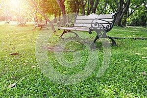 Metal garden chair on green grass with burst light