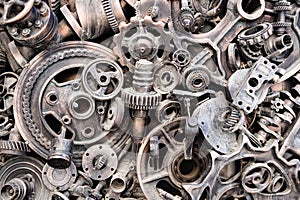 Metal gears background. Old and rusty spare parts for industrial machines in a landfill.