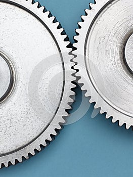 Metal gears on blue background.