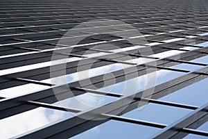 Metal girders joining glass panels of a wall