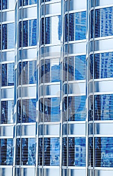 Metal glass facade blue colour of skyscraper. Fragment of the modern building. Many windows pattern