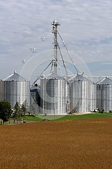 A metal grain facility with silos