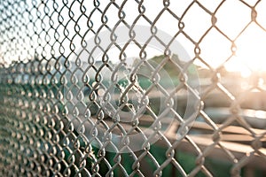 Metal grid and blurred city on the background
