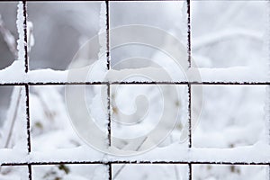 Metal grid covered with snow