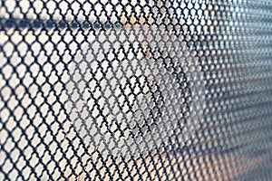 Metal grid with numerous small cells on light background
