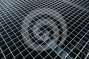 metal grid of square holes background. Gray street lattice