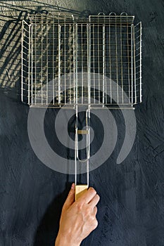 Metal grill for cooking on fire and charcoal. Flat lay. Template for the designer. Vertical photo