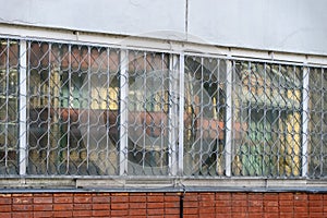 Metal grille guards with pattern on the window of the building
