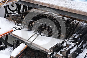 Metal grills for barbecue cooking lie on the street in winter weather