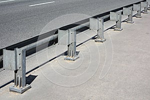 Metal guardrail on an asphalt bridge