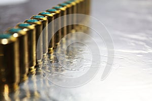 Metal gun hubs munitions on shiny silver desk