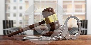 Metal handcuffs and judge gavel on wooden desk, blur office background. 3d illustration