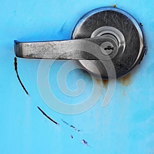 Metal Handle on Blue Metal Door with Lock for Security Scratch Mark