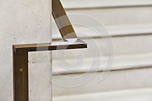 A metal handrail inside the building to hold while going down