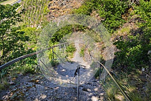 Metal handrail and rail on the trail in wineries on a steep slate trail.