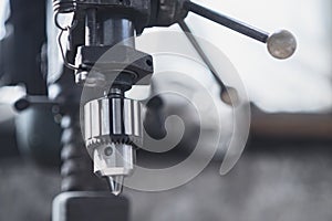 Metal head drilling machine. Image is tinted
