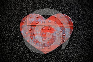Metal heart on a dark texture