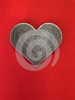 Metal heart on a red background