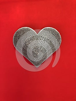 Metal heart on a red background