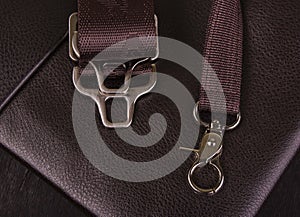 Metal hooks on the leather pouch close-up