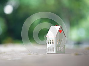 Metal house with inner glowing on dark night and blue background, with copy space