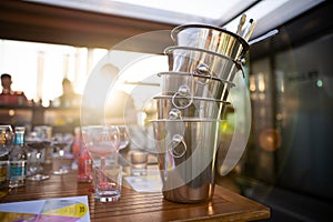 metal ice bucket on bar counter with ice scoop tool