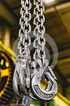 Metal industrial chains with hooks in the workshop of a metallurgical plant