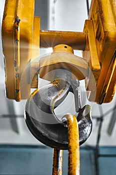 Metal industrial chains with hooks in the workshop of a metallurgical plant. Close-up. Lifting hooks for lifting heavy materials