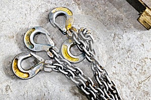 Metal industrial chains with hooks in the workshop of a metallurgical plant. Close-up. Lifting hooks for lifting heavy materials