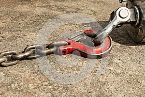 Metal industrial hook on the concrete floor of a steel plant. Close-up. Lifting hooks for heavy materials and equipment. Cargo